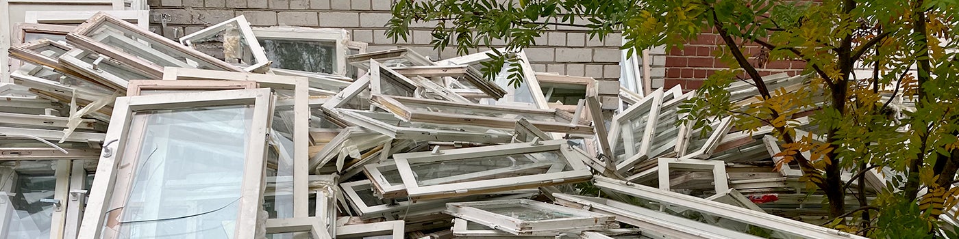 Large pile of glass windows for scrap glass recycling