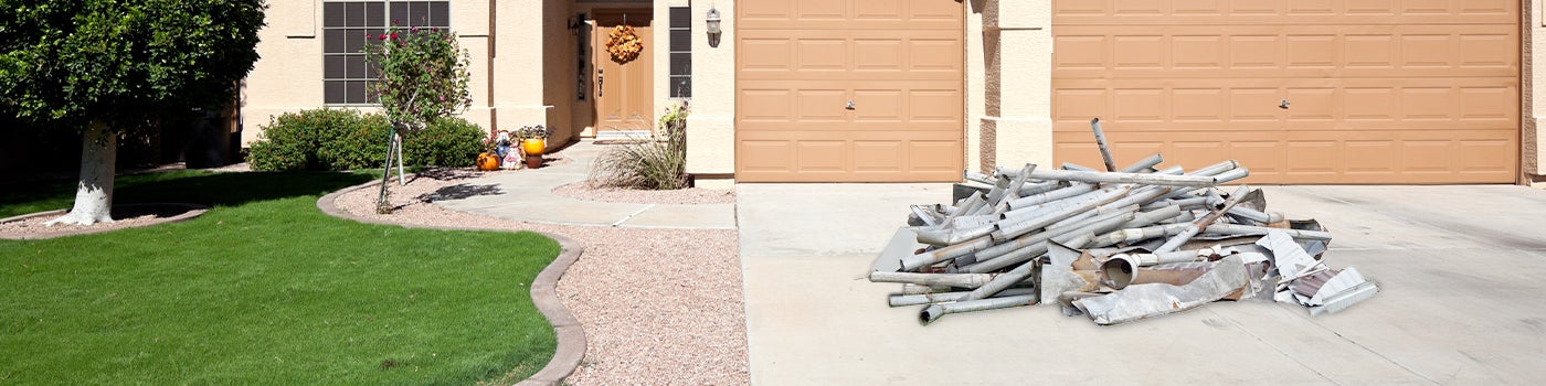 Driveway with a pile of scrap metal for pickup and disposal